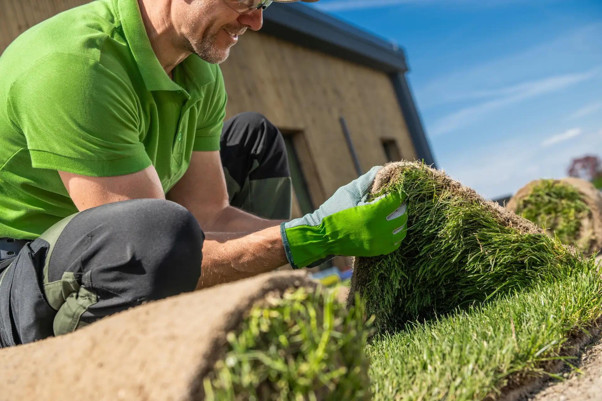 Professional Landscaper Laying Grass on Lawn